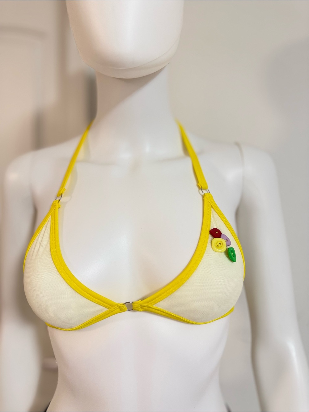 Yellow-Trim Cream Bralette with Decorative Buttons
